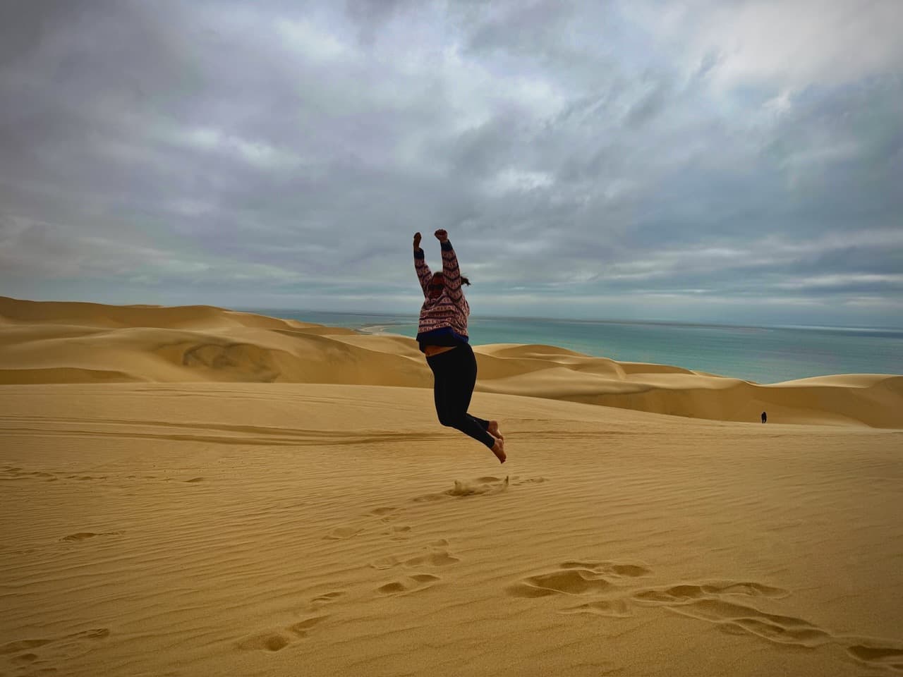J. jumping on top of the dunes, where the Namib Desert meets the Atlantic