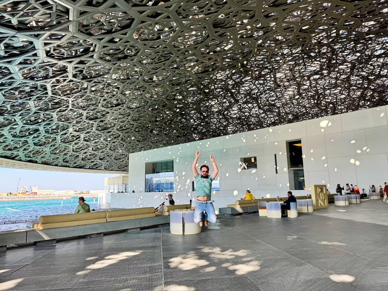 Jumping under the dome of the Louvre Abu Dhabi, in its rain of light