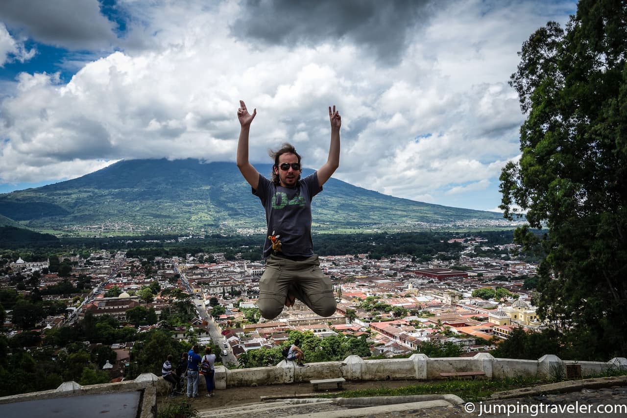 Jumping in of Antigua and its volcano in the clouds.