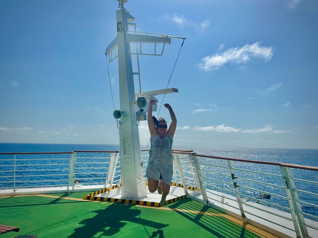 J. jumping by the mast, with the Atlantic all around