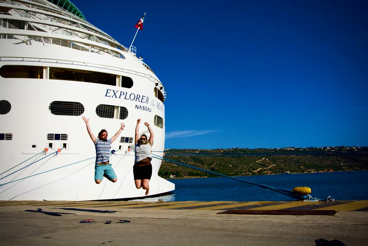 J. and I jumping in front of Explorer of the Seas in Souda