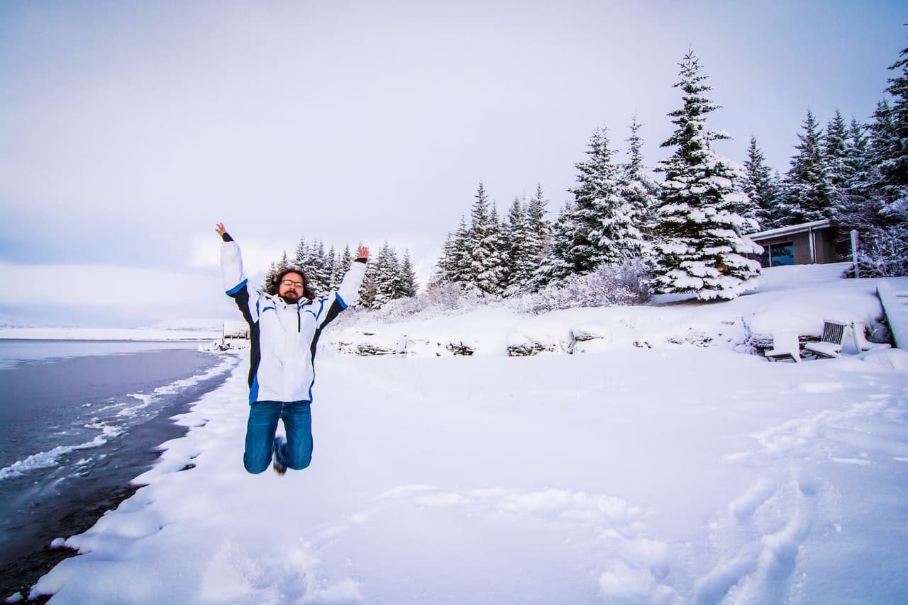 Jumping in the snow on the shore of Álftavatn Lake