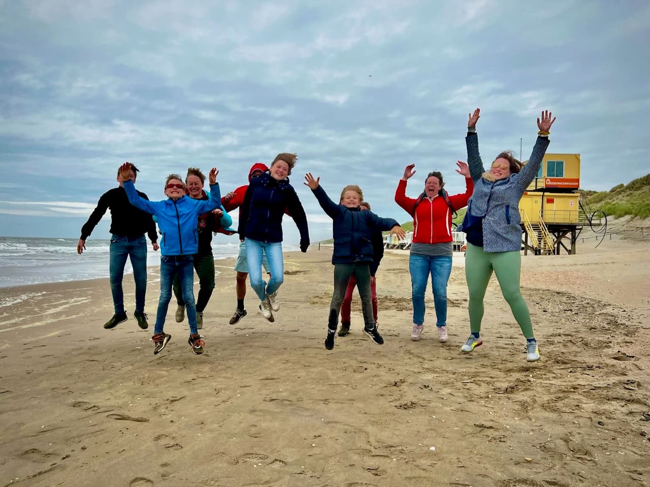 Family jumping on the beach at Castricum aan Zee