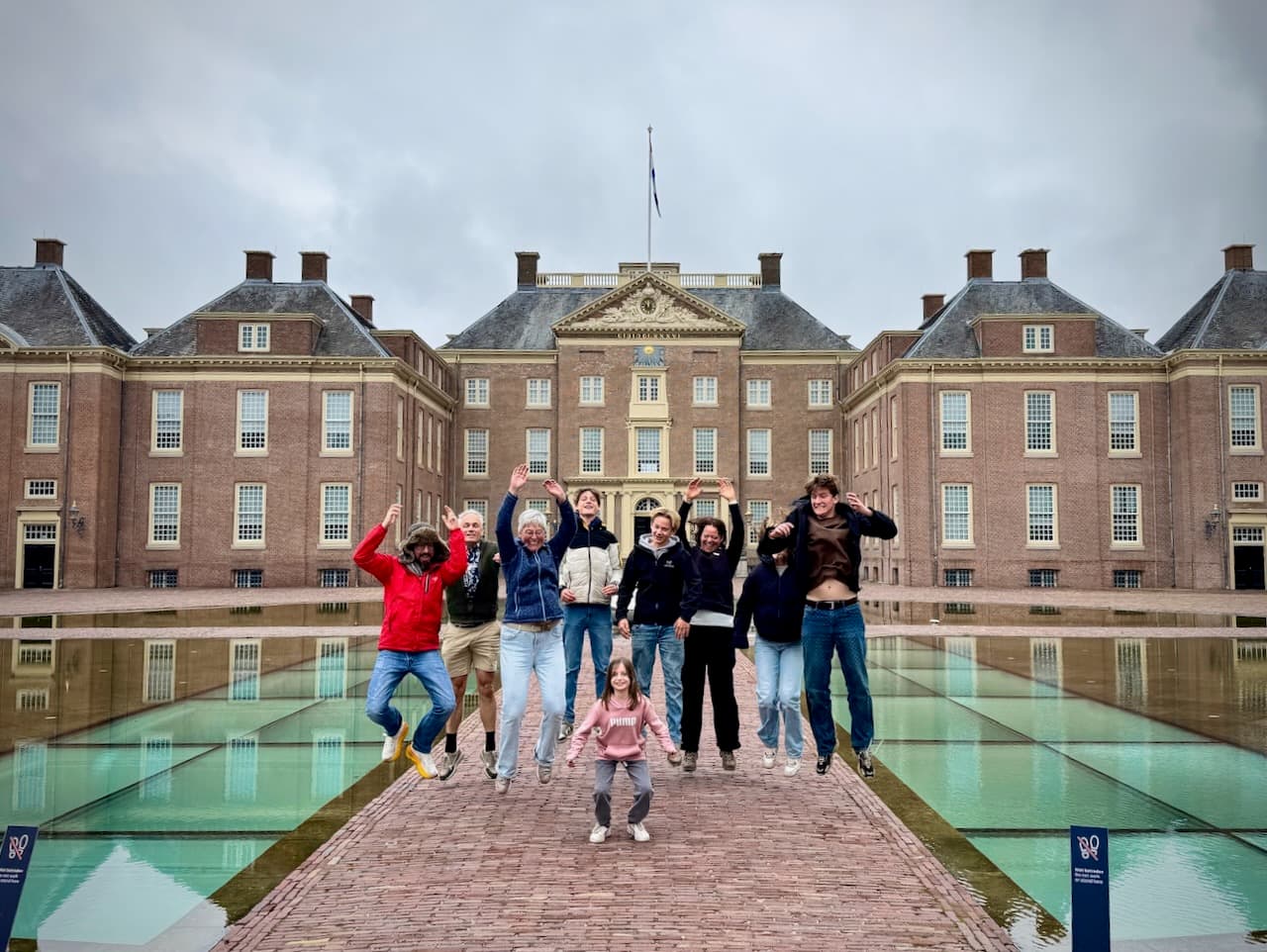 Jumping with family between the reflecting pools in front of Paleis Het Loo