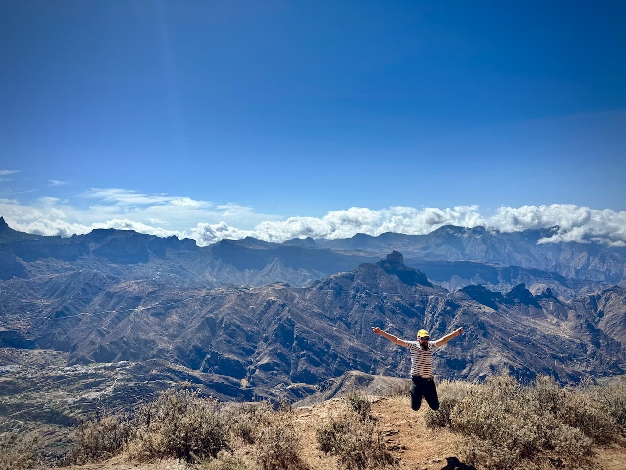Jumping above the mountains in the centre of Gran Canaria, with Roque Bentayga in the distance